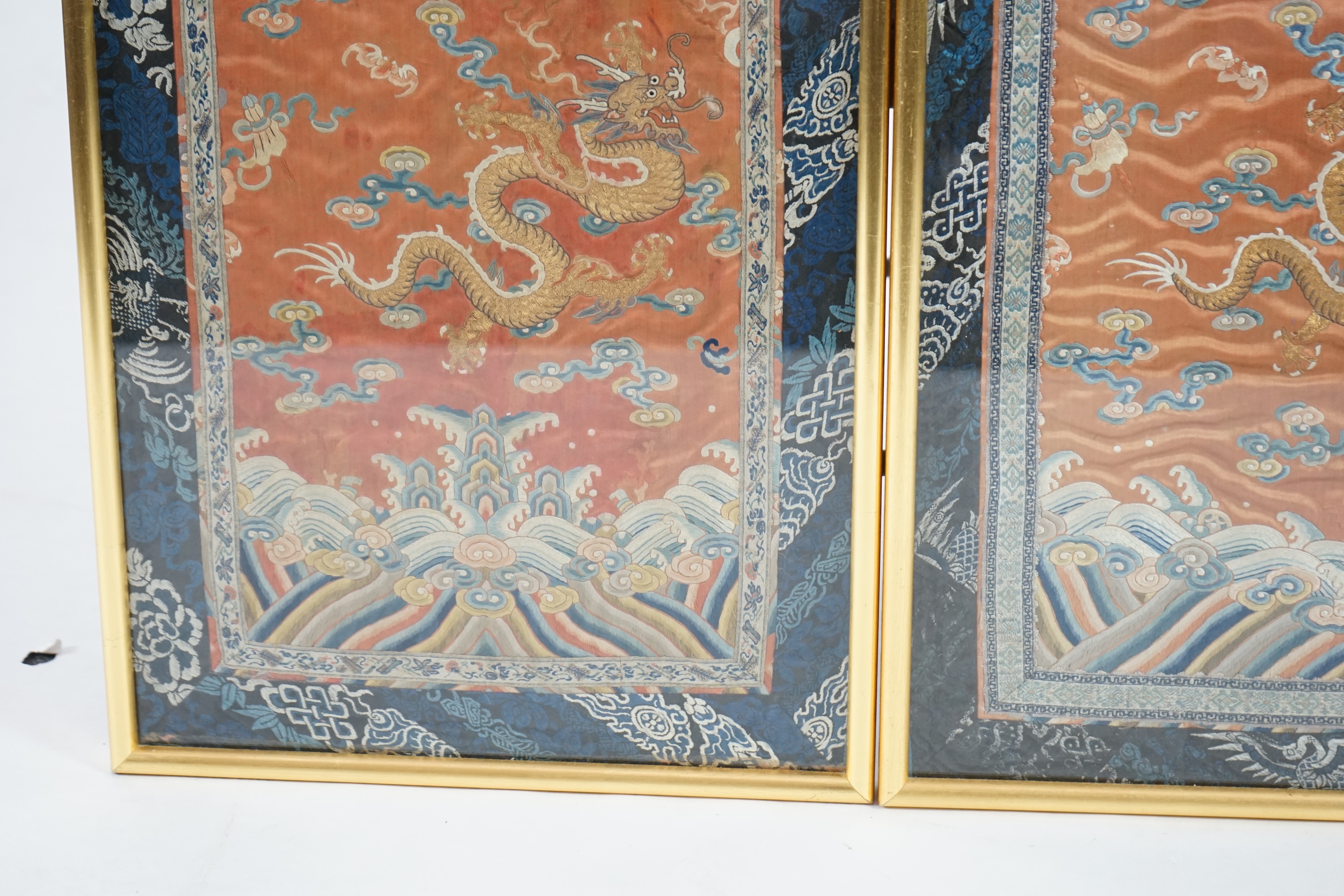 A pair of Chinese coral silk ‘dragon’ panels, 19th century